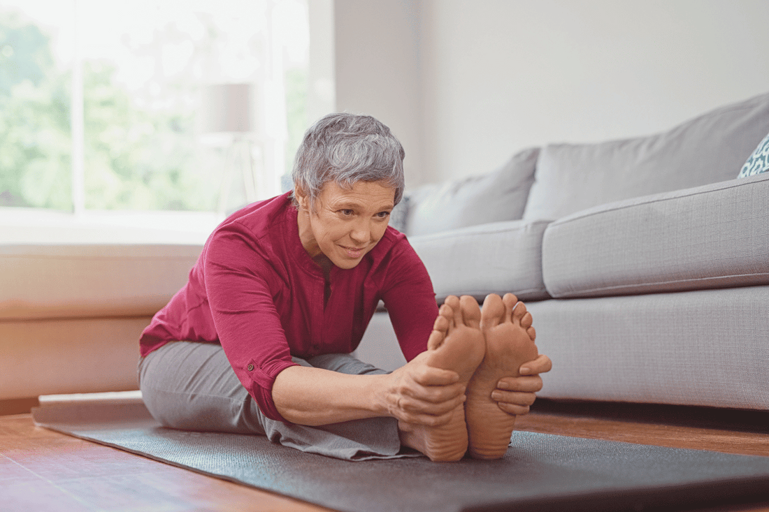 Woman stretching on yoga mat