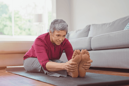 Woman stretching on yoga mat